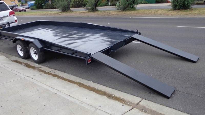 A Black Trailer With Ramps Is Parked On The Side Of The Road - Voyager Trailers in Yarrawonga, NT