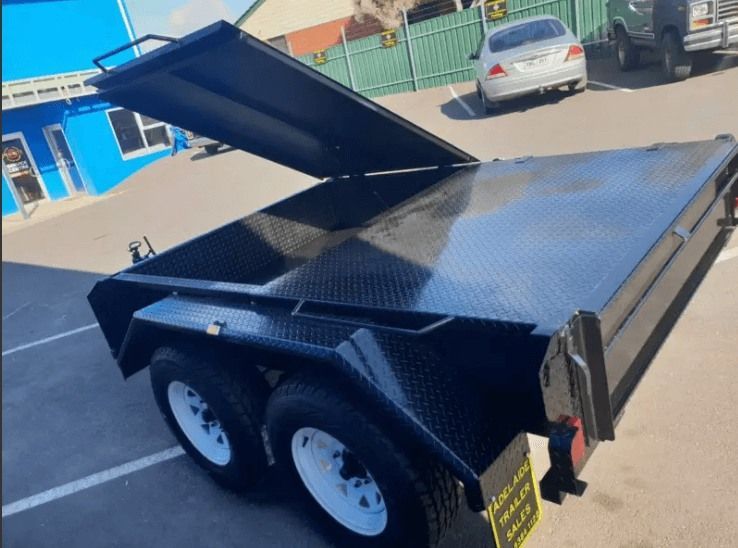 A Black Trailer With the Lid Open is Parked in a Parking Lot — Voyager Trailers in Yarrawonga, NT