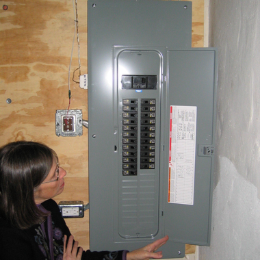 Woman looking at an electric box - Grand Rapids, Michigan - Wireworks Electric Inc.