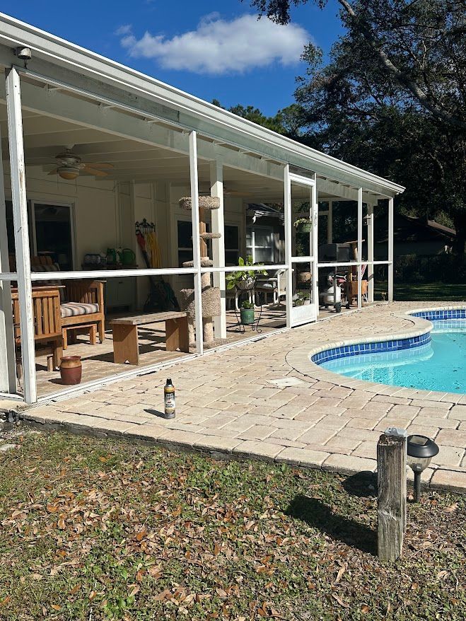 A house with a swimming pool in front of it