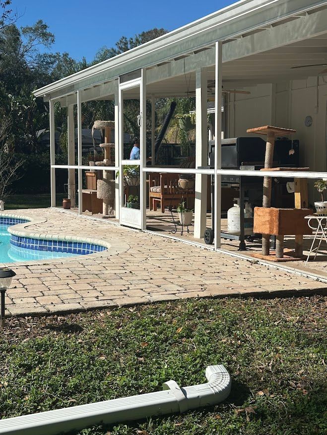 A house with a pool and a screened in porch