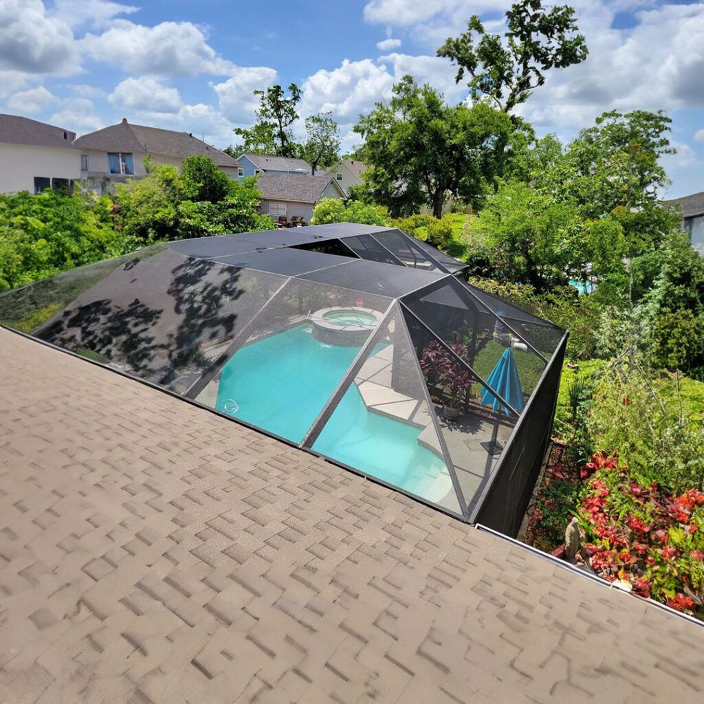 A view of a swimming pool from the roof of a house.