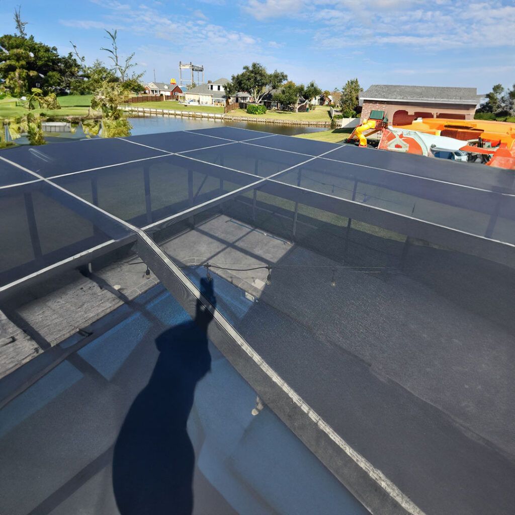 A shadow of a person is cast on a glass roof