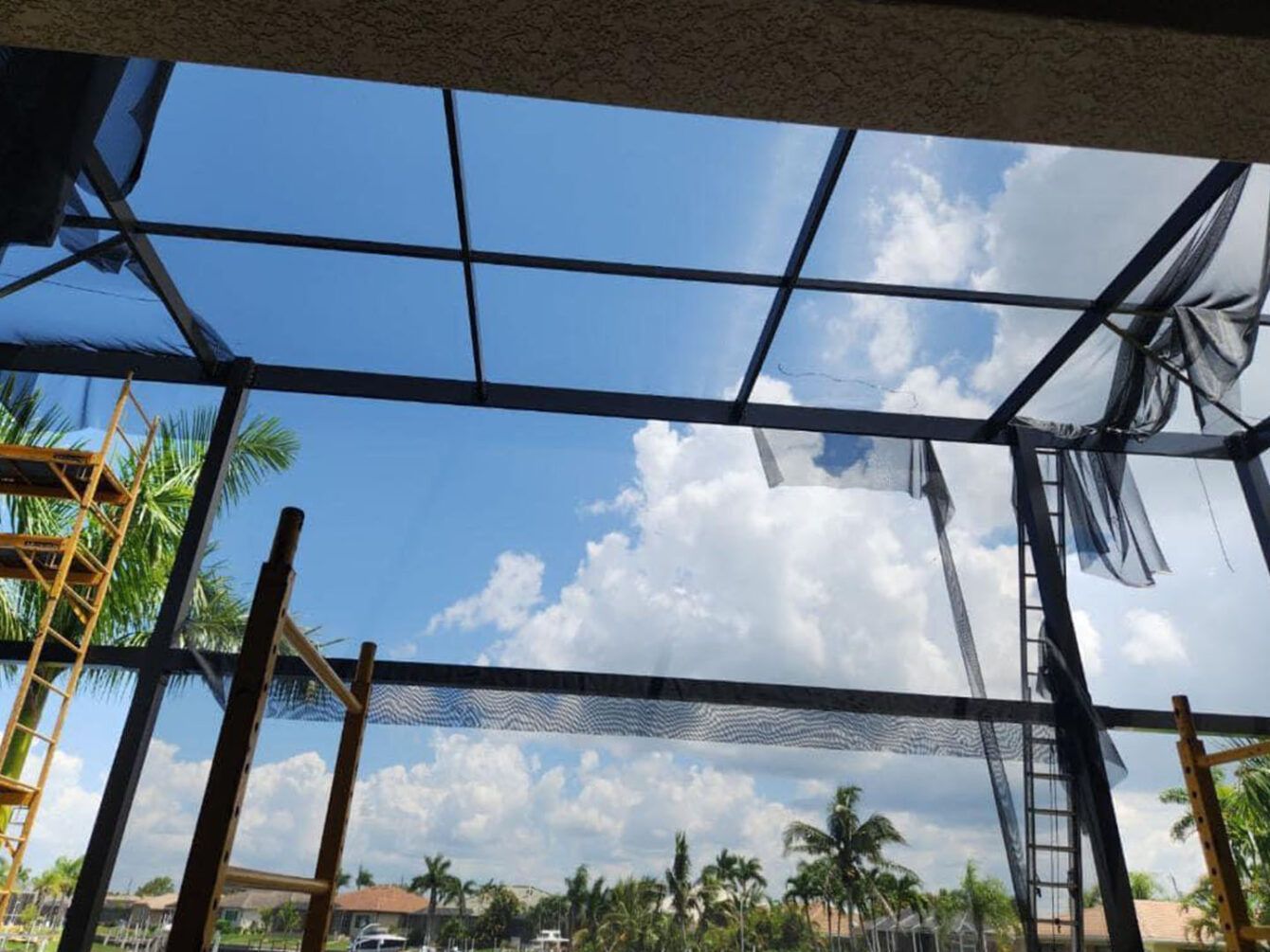 A roof with a blue sky and clouds behind it