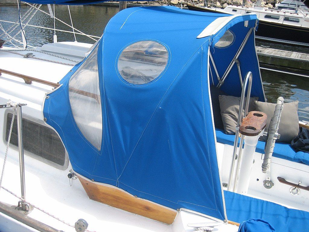 A boat with a blue canopy on top of it