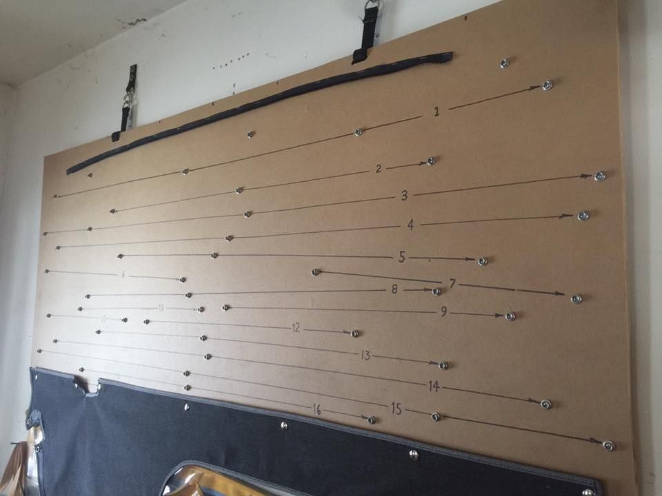 A large piece of cardboard is hanging on a wall