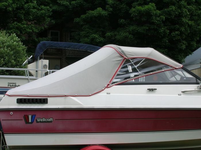 A red and white boat with the letter v on the side