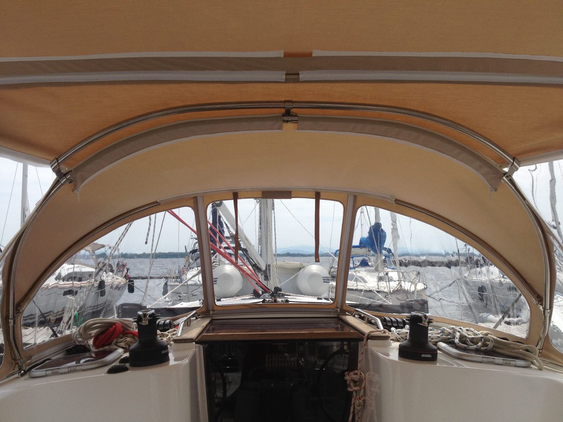 The inside of a sailboat with a canopy over the cockpit