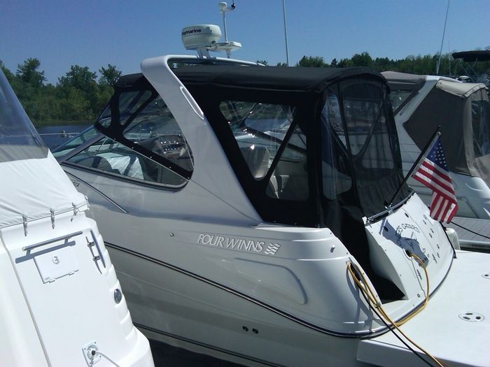 A white boat with the name four winds on the side