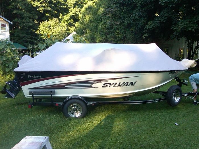 A sylvania boat is covered in a white tarp