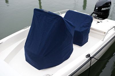 A white boat with a blue cover on the seats