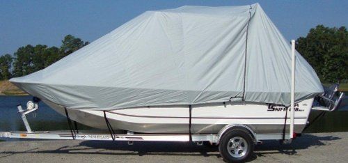 A boat on a trailer with a white cover on it