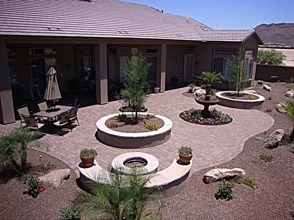A patio with a fire pit and a table and chairs