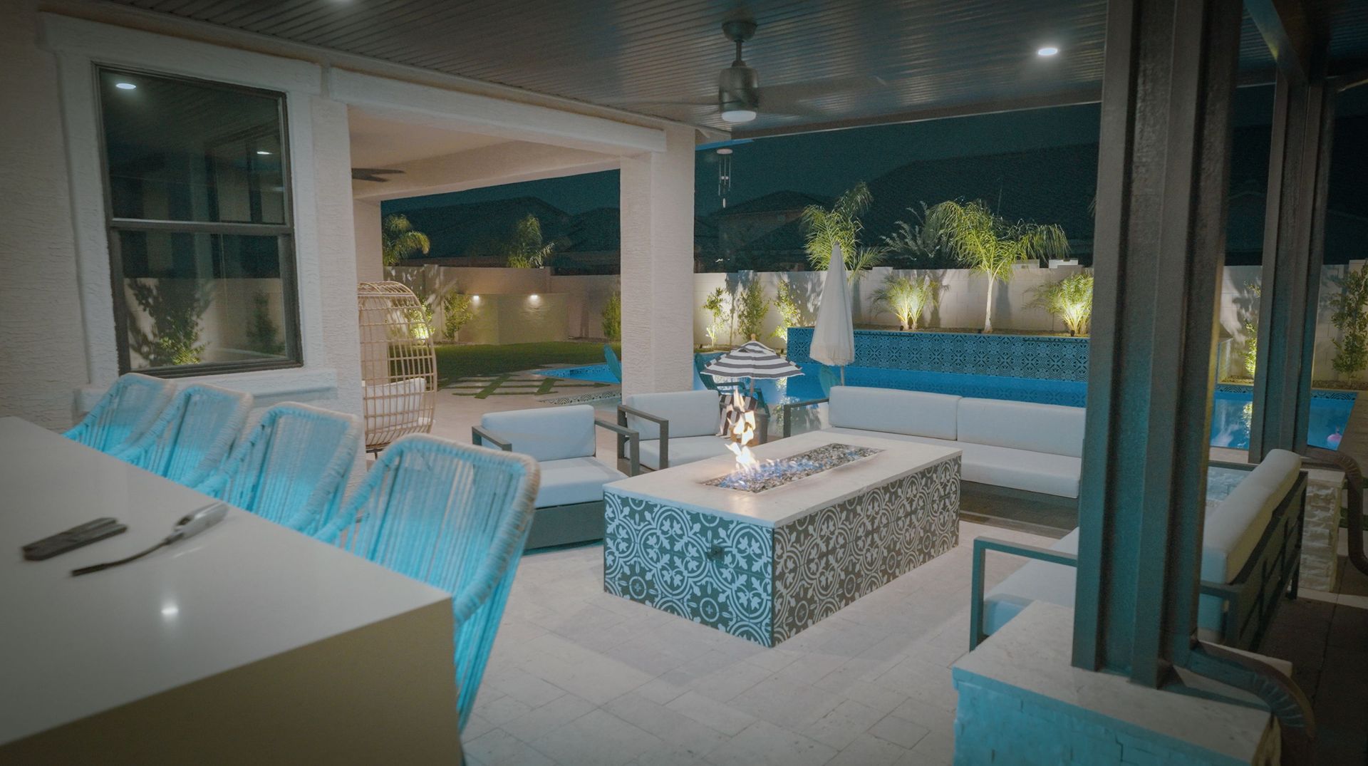 There is a fire pit in the middle of the patio.