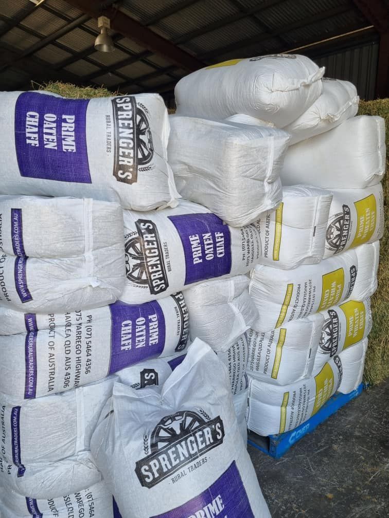 A Stack Of Bags Of Springer's Prime Hay — SF Produce In Paget, QLD