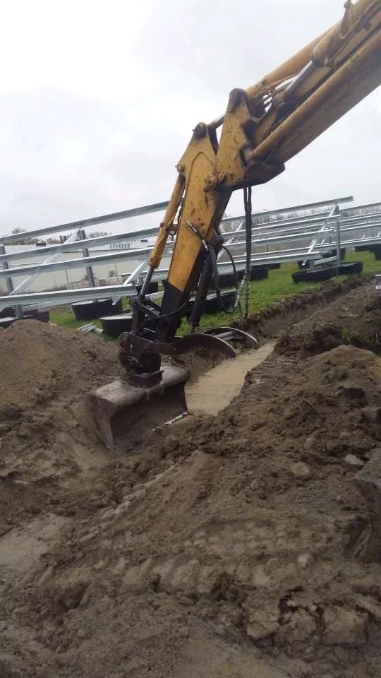 backhoe digging into dirt