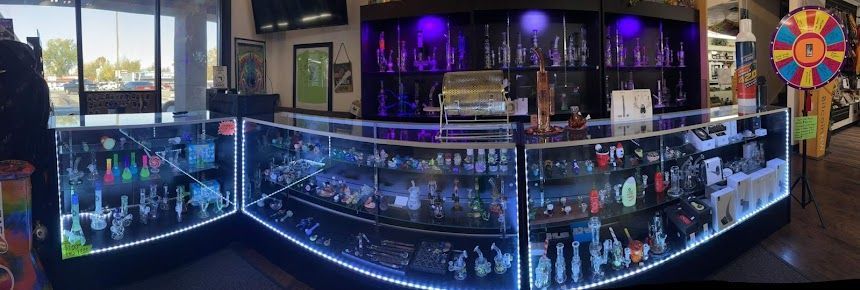 A panoramic view of a store filled with lots of glass display cases.