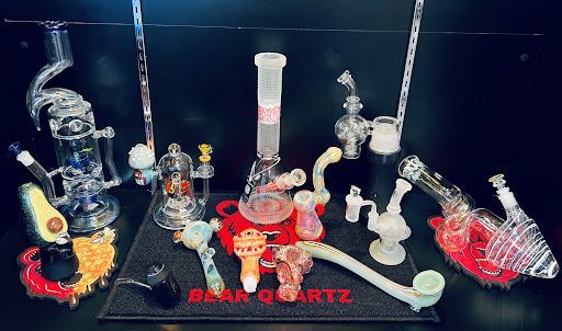 A group of glass pipes are sitting on top of a black mat.