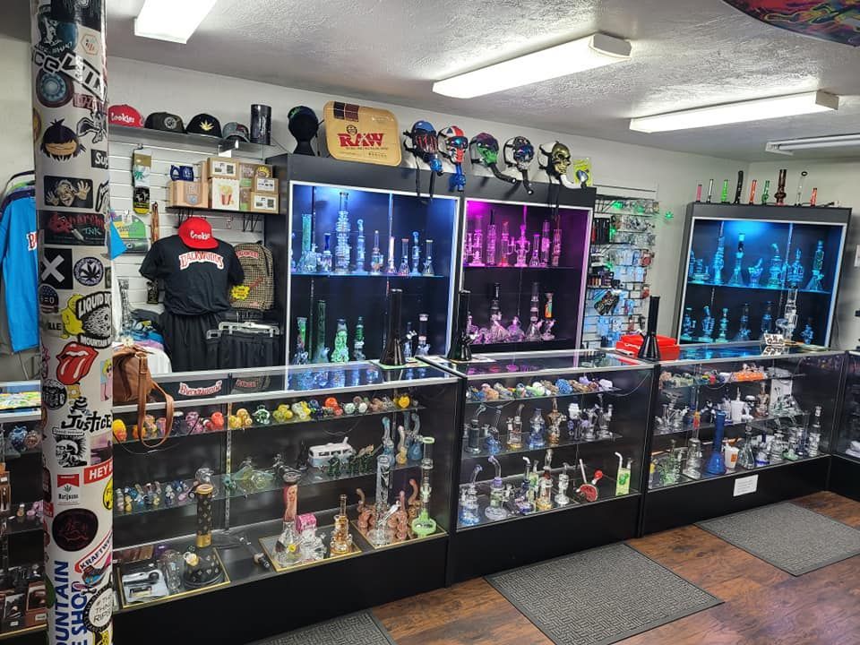 A store filled with lots of glass pipes and shirts.