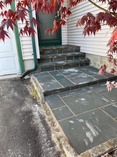 A stone walkway leading to the front door of a house