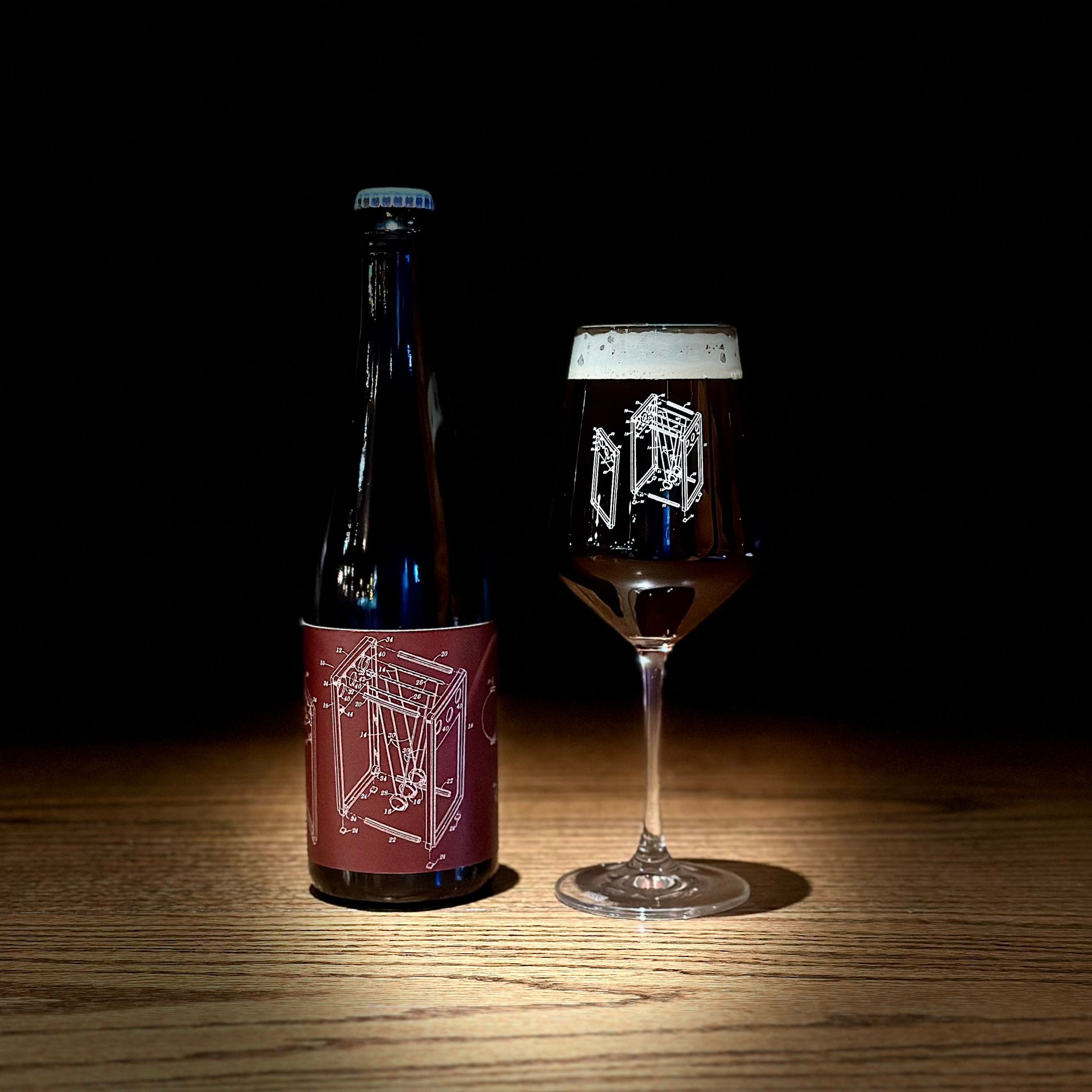 A bottle of beer and a glass of beer on a wooden table