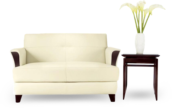 A White Couch with A Vase of Flowers Next to It