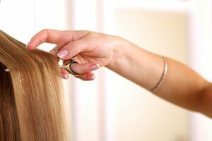 Woman holding scissors — Hair Specials in Shelby Township, MI