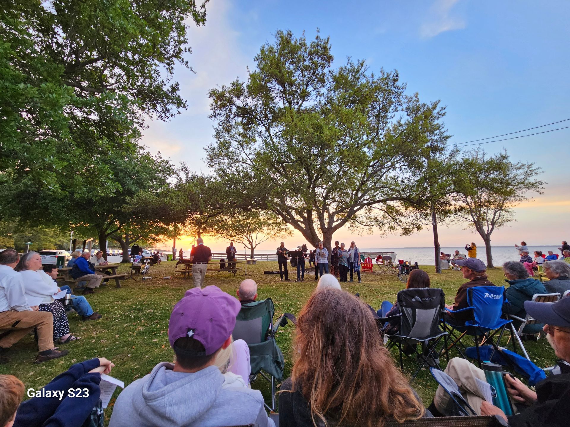 Woman with gray hair smiles, wearing a floral kimono.