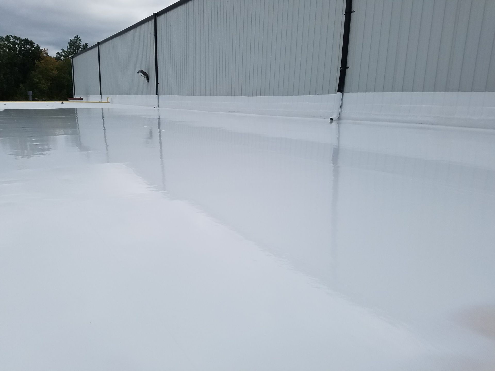 A large white building with a white roof.