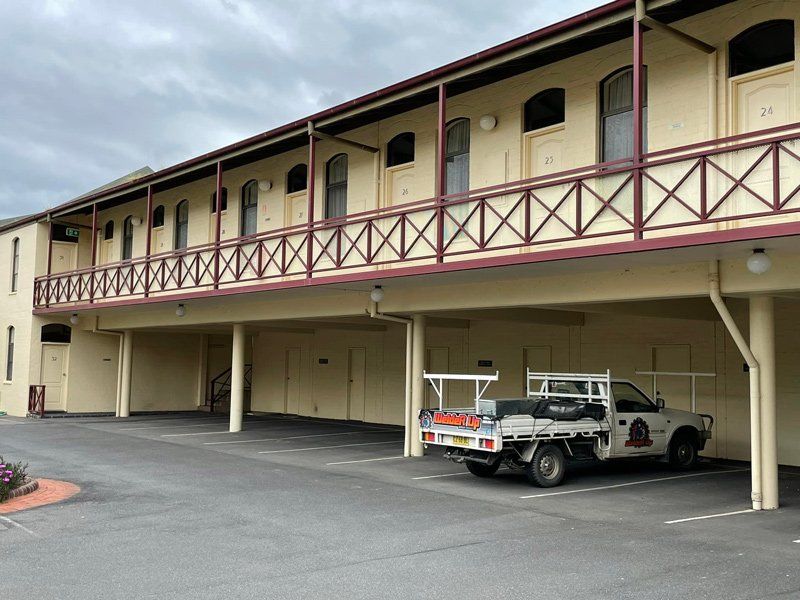 Building with Red Balcony Railings — Welding in Wagga Wagga, NSW