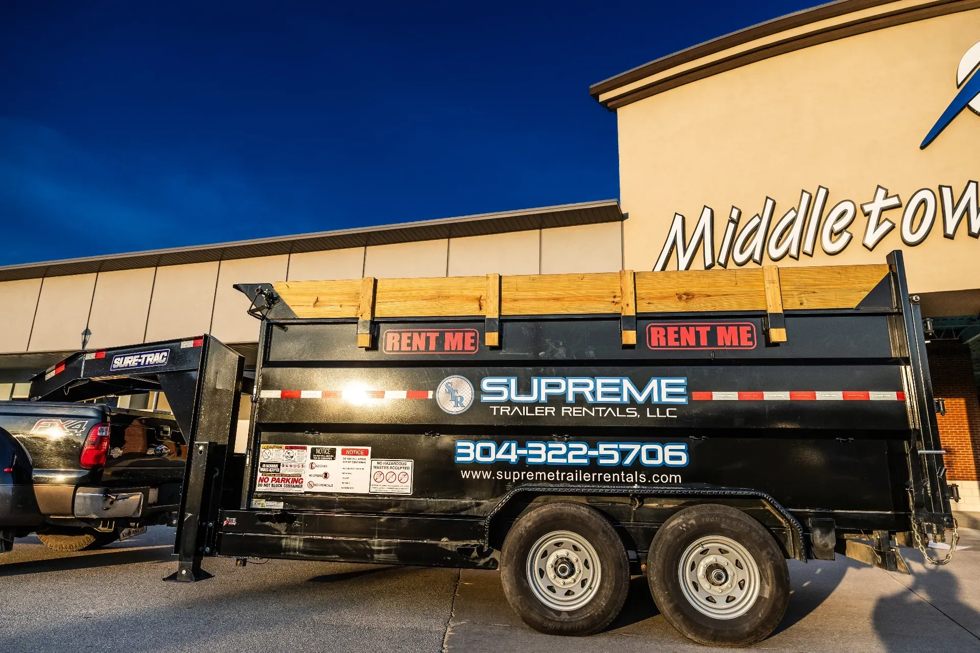 A black Supreme Dumpster trailer with