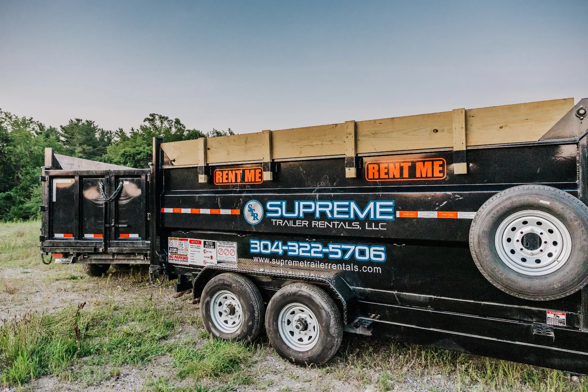 Black Supreme Dumpster Rentals trailer with the phone number 304-322-5706 on the side,