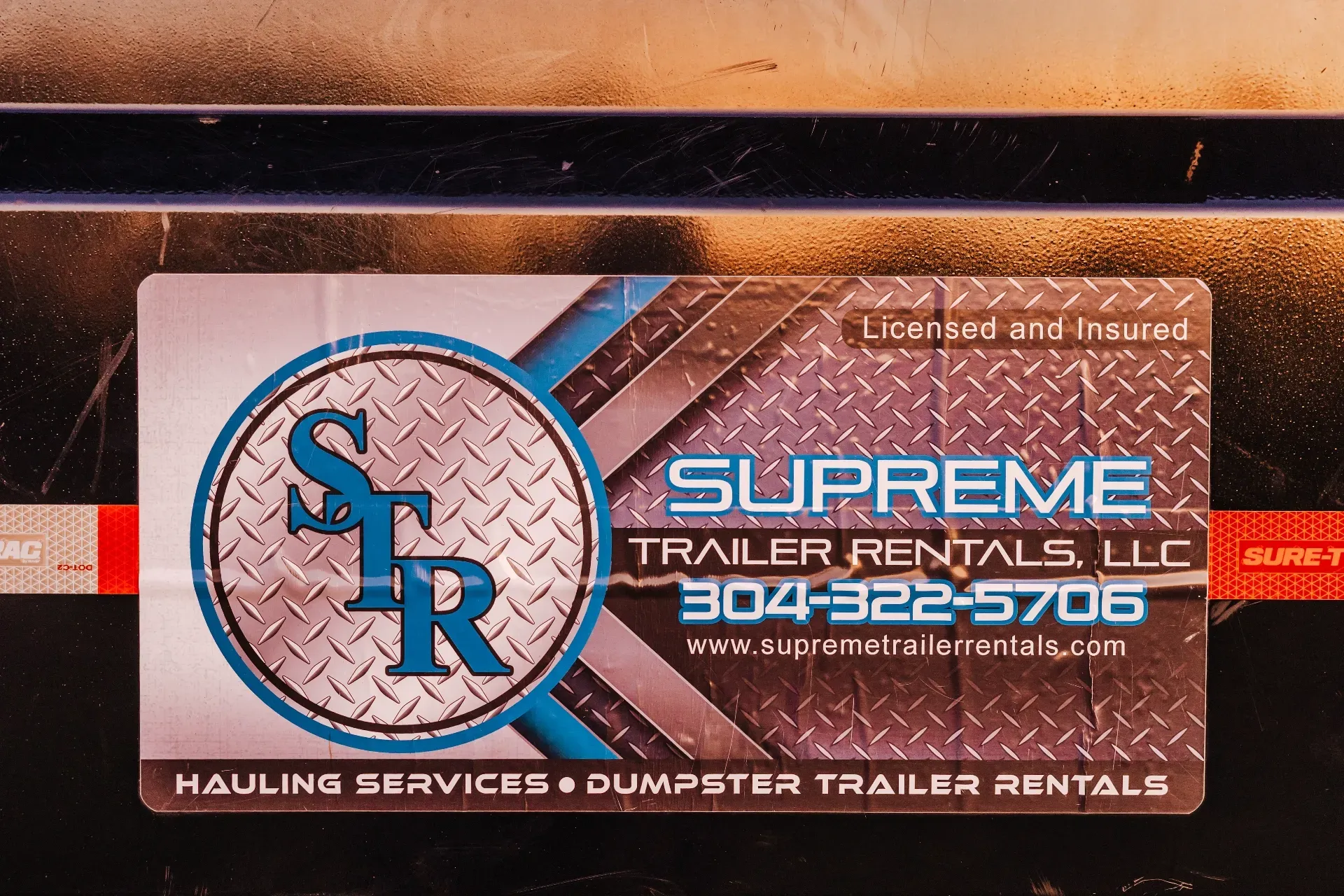 Business card for Supreme Trailer Rentals, LLC, blue and silver logo with phone number and website.