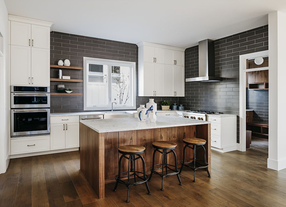 A Kitchen With Stone Benchtop With White Cabinets — Stone Theory In Queanbeyan West, NSW