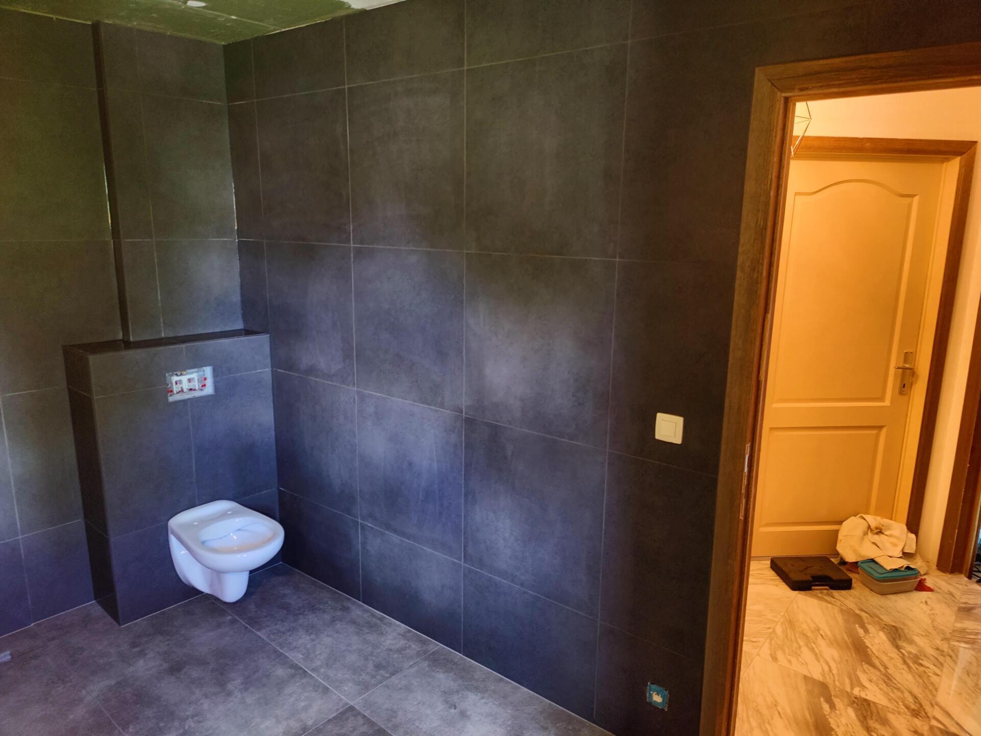 A bathroom with a toilet and a door.