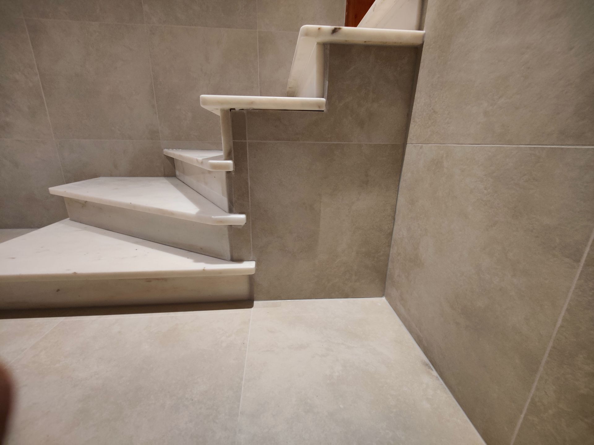 A staircase in a room with a tiled floor