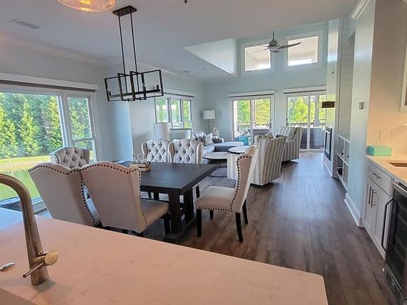 A kitchen and dining room in a house with a table and chairs.