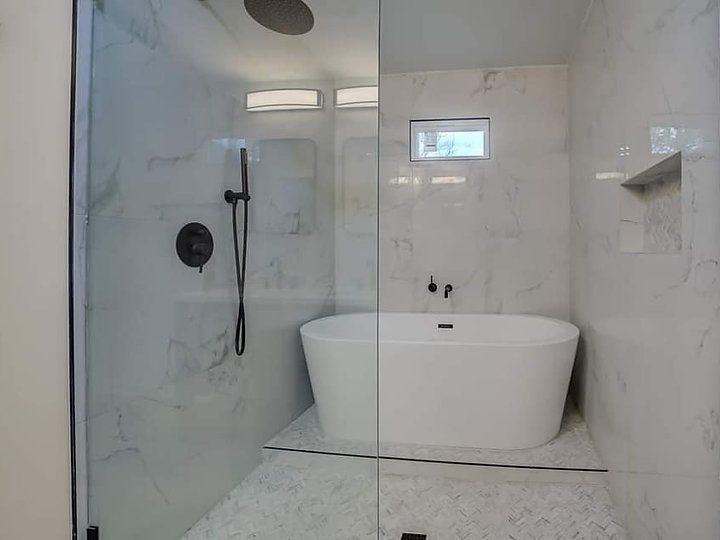 A bathroom with a bathtub and a walk in shower.