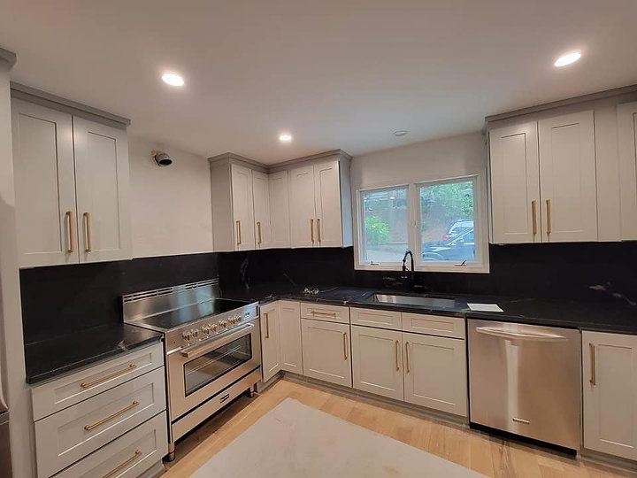 A kitchen with white cabinets and stainless steel appliances.