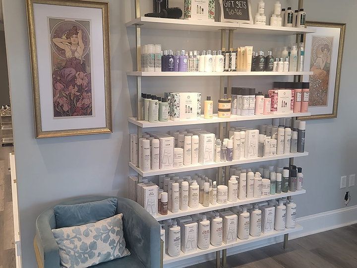 A shelf filled with lots of hair products in a salon.