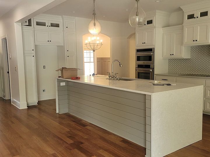 There is a large island in the middle of the kitchen.