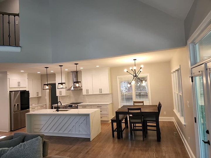 A kitchen with a table and chairs in it