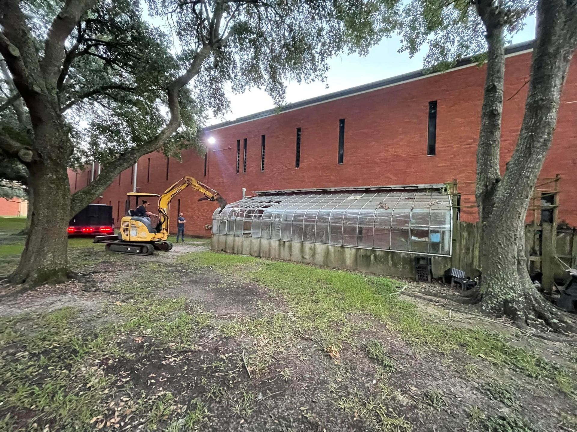 A large building is being demolished by a bulldozer