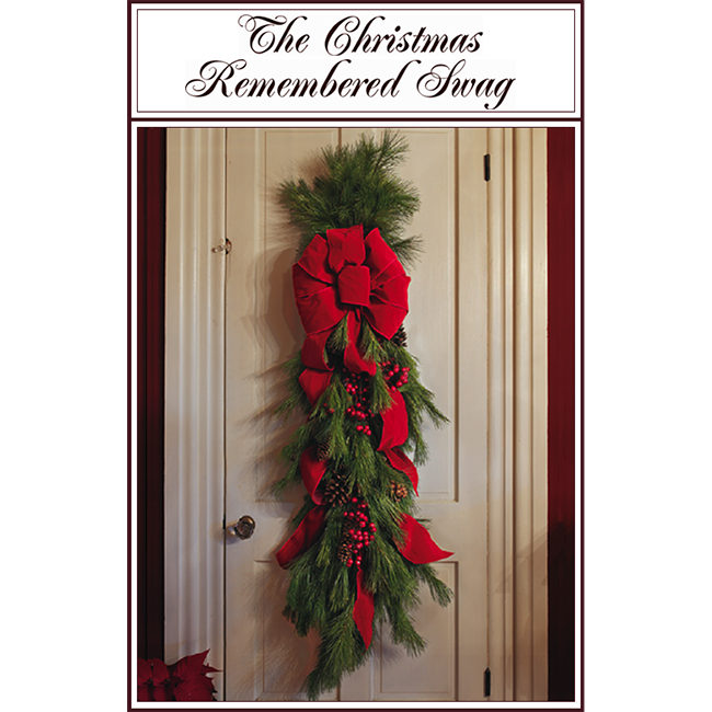 Book cover with title “The Christmas Remembered Song” and a red bow on a green garland hanging on a door