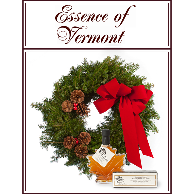 Essence of Vermont gift set with evergreen wreath, red bow, and perfume bottle with box