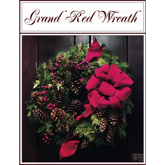 Grand Red Wreath with burgundy bow, pinecones, and greenery on a dark wooden background