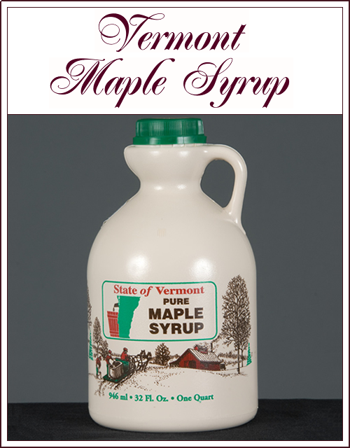 White jug labeled Vermont Maple Syrup with green cap on dark background