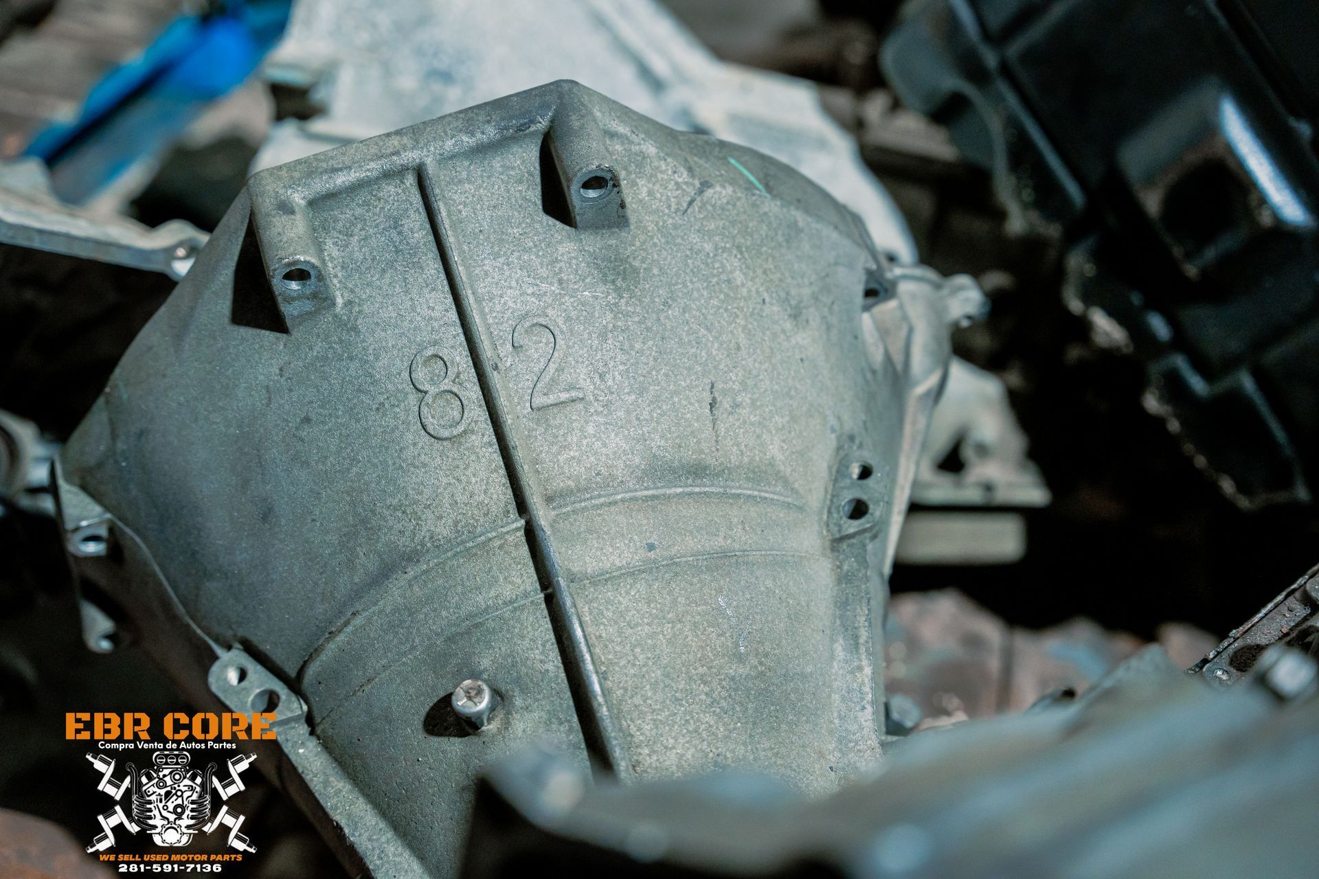 Close-up of a gray, cast-metal engine part with the number 