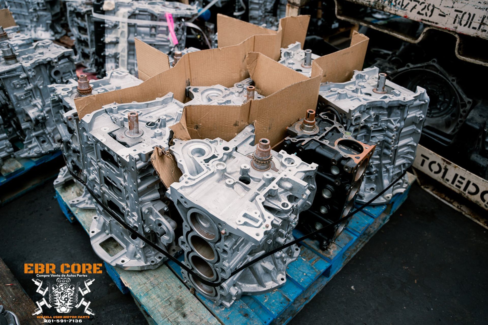 Engine blocks stacked on pallets, ready for parts or recycling.