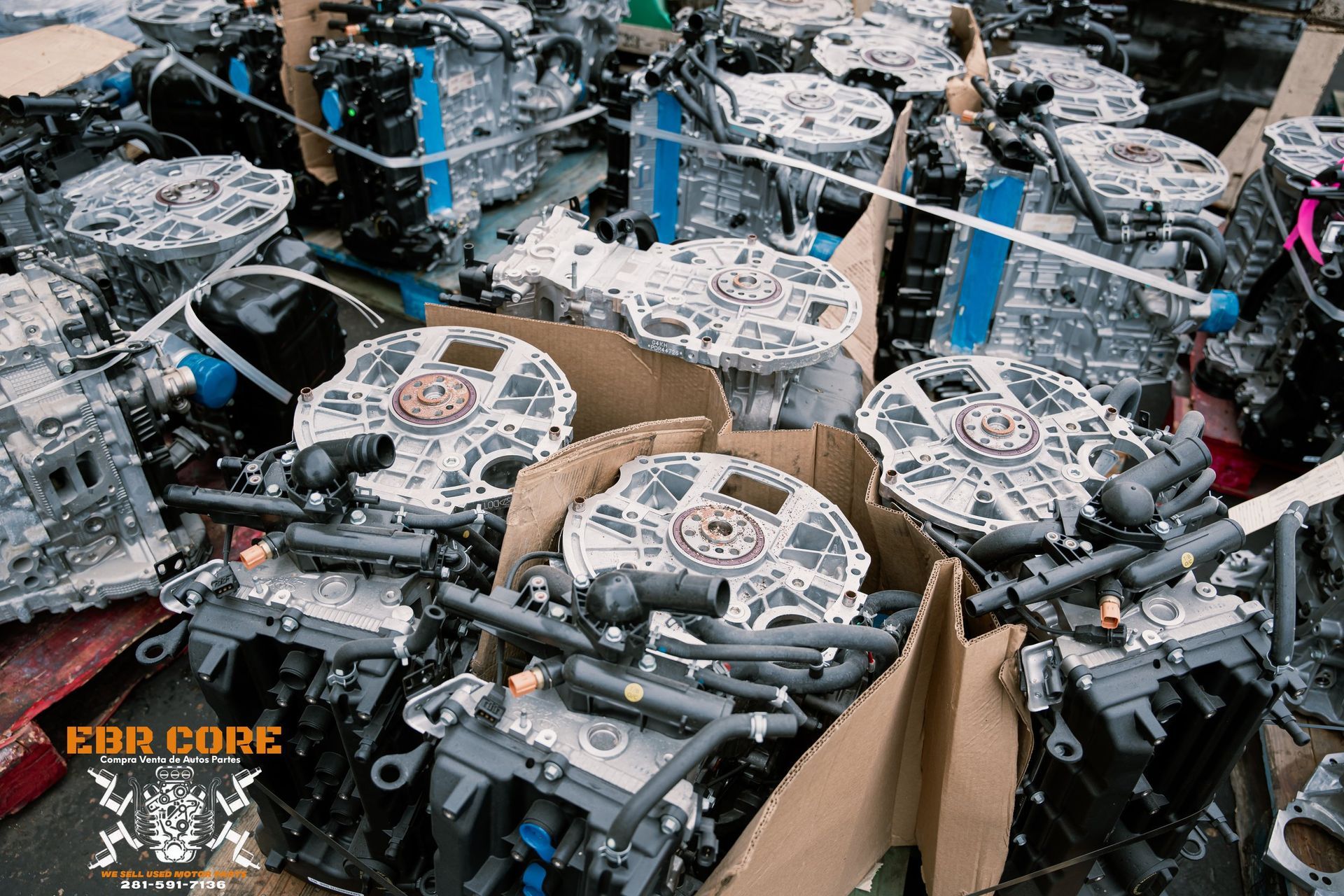 Scrap metal parts piled in cardboard boxes, potential engine components.